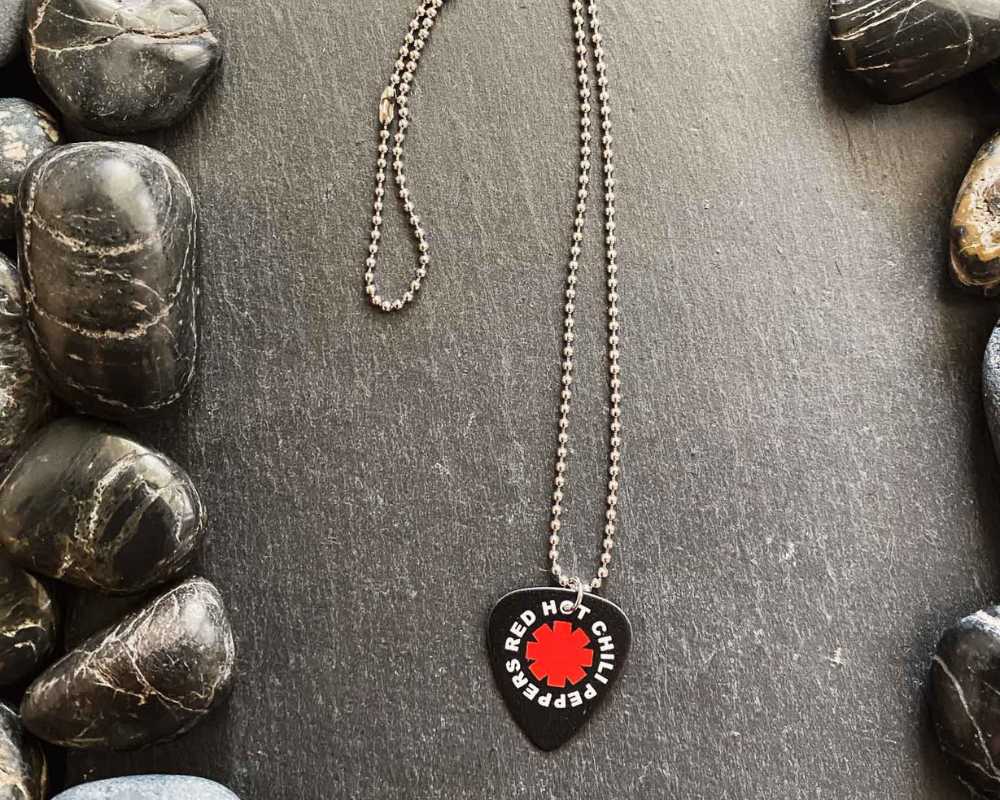Red Hot Chili Peppers guitar pick necklace. Band merch available at Rock & Roll Jane