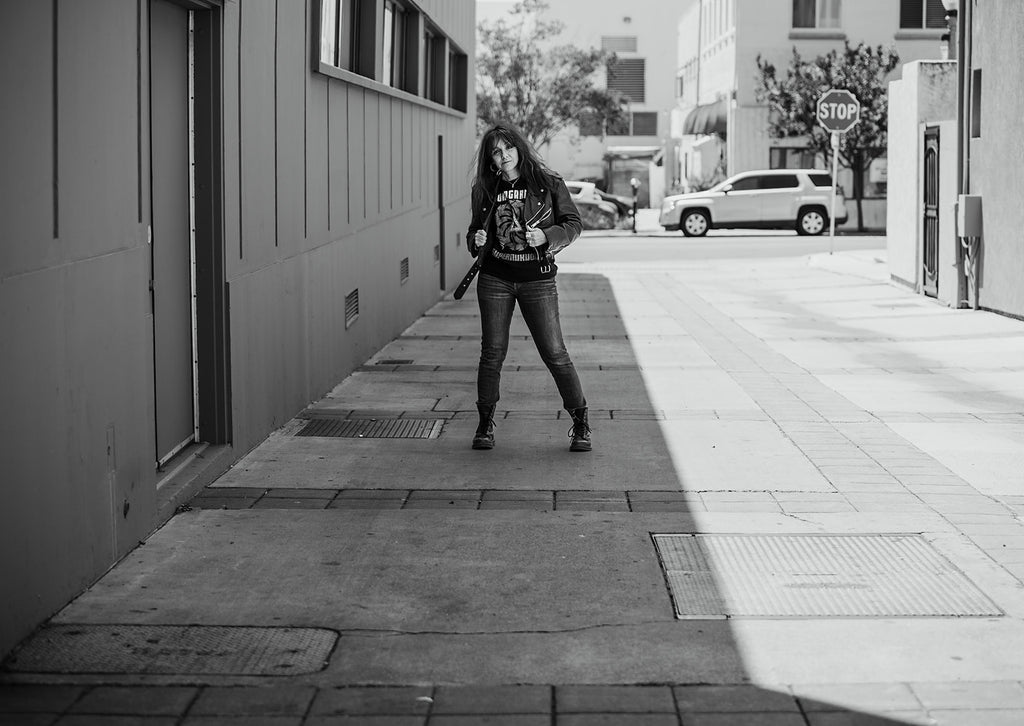 Woman standing in alley wearing a Soundgarden t-shirt and leather jacket | Rock & Roll Jane | Officially licensed band tees and accessories