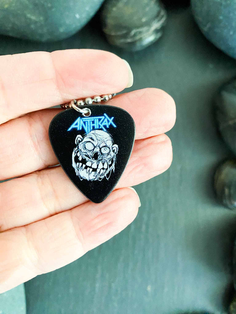 Anthrax guitar pick necklace featuring "Zombie Notman" artwork on both side | 18" silver ball chain plus extra cord for versatility | Shop officially licensed band tees and band merch at Rock & Roll Jane