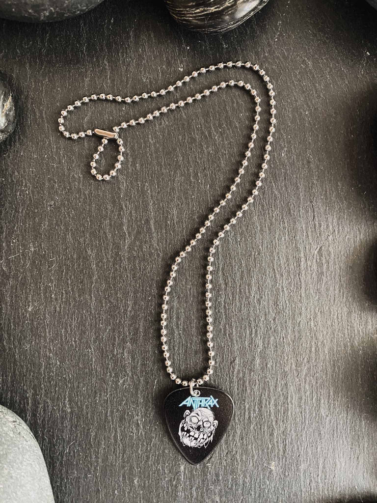 Anthrax guitar pick necklace featuring "Zombie Notman" artwork on both side | 18" silver ball chain plus extra cord for versatility | Shop officially licensed band tees and band merch at Rock & Roll Jane