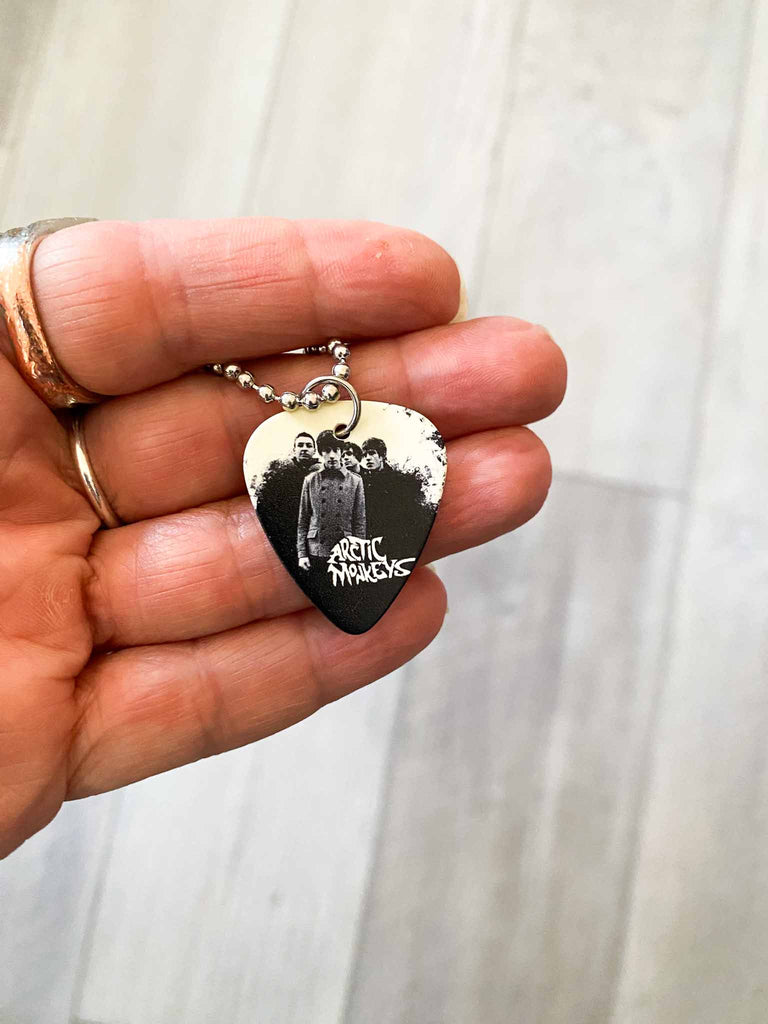 Arctic Monkey Guitar Pick Necklace | 18" stainless steel ball chain | Fast shipping | Shop officially licensed band tees and more at Rock & Roll Jane