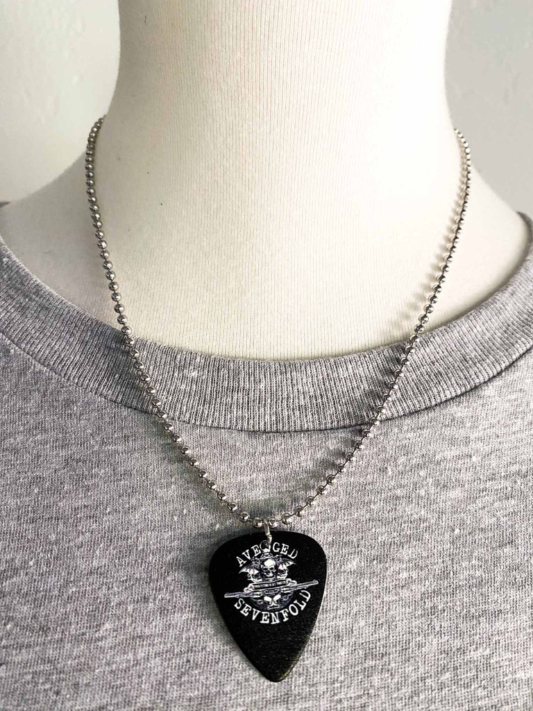 Avenged Sevenfold guitar pick necklace feature the band's death bat logo on both sides | 18" silver ball chain plus an extra cord for versatility | Shop officially licensed band tees and band merch at Rock & Roll Jane