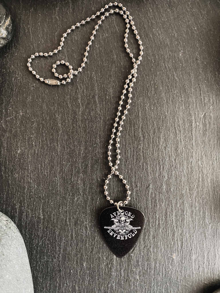 Avenged Sevenfold guitar pick necklace feature the band's death bat logo on both sides | 18" silver ball chain plus an extra cord for versatility | Shop officially licensed band tees and band merch at Rock & Roll Jane