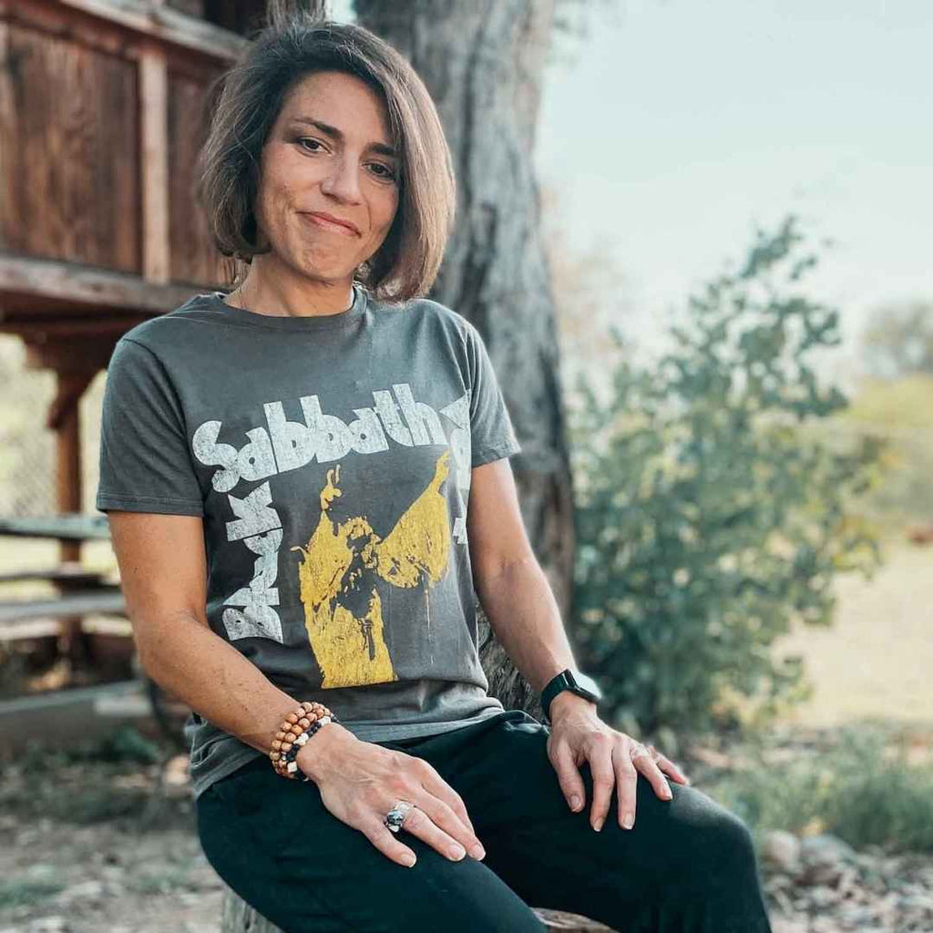 Woman sitting down wearing a Black Sabbath Vol. 4 t-shirt | Rock & Roll Jane