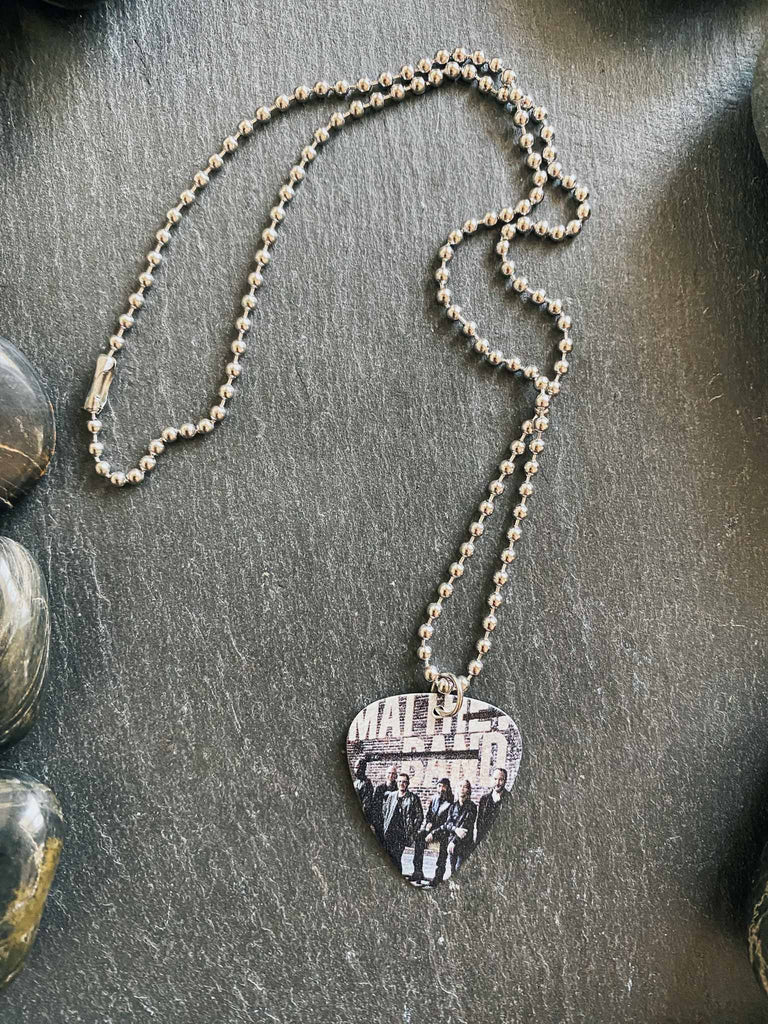 Dave Matthews guitar pick necklace featuring a photo  of the band | Hangs on an 18" silver ball chain and comes with an extra cord | Available at Rock & Roll Jane | We carry officially licensed band tees and accessories