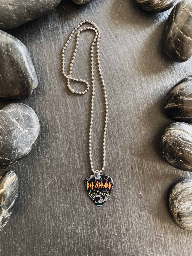 Def Leppard Guitar Pick Necklace featuring graphic on both sides on an 18" stainless steel ball chain | Fast shipping and free stickers with every order | Shop officially licensed band tees and more at Rock & Roll Jane