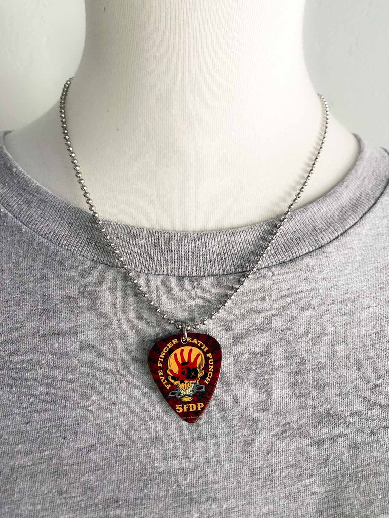 Five Finger Death Punch guitar pick necklace featuring the band's skull and hand logo on both sides | 18" silver ball chain plus extra cord for versatillity | Shop officially licensed band tees and band merch at Rock & Roll Jane