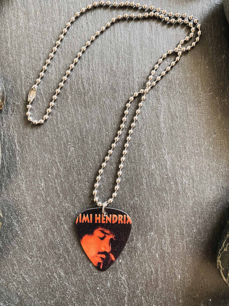 Jimi Hendrix guitar pick necklace featuring a photo of Jimi | hangs on an 18" silver ball chain | Available at Rock & Roll Jane | We carry officially licensed band tees and accessories