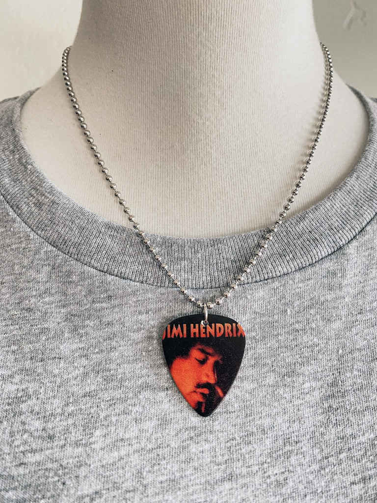 Jimi Hendrix guitar pick necklace featuring a photo of Jimi | hangs on an 18" silver ball chain | Available at Rock & Roll Jane | We carry officially licensed band tees and accessories