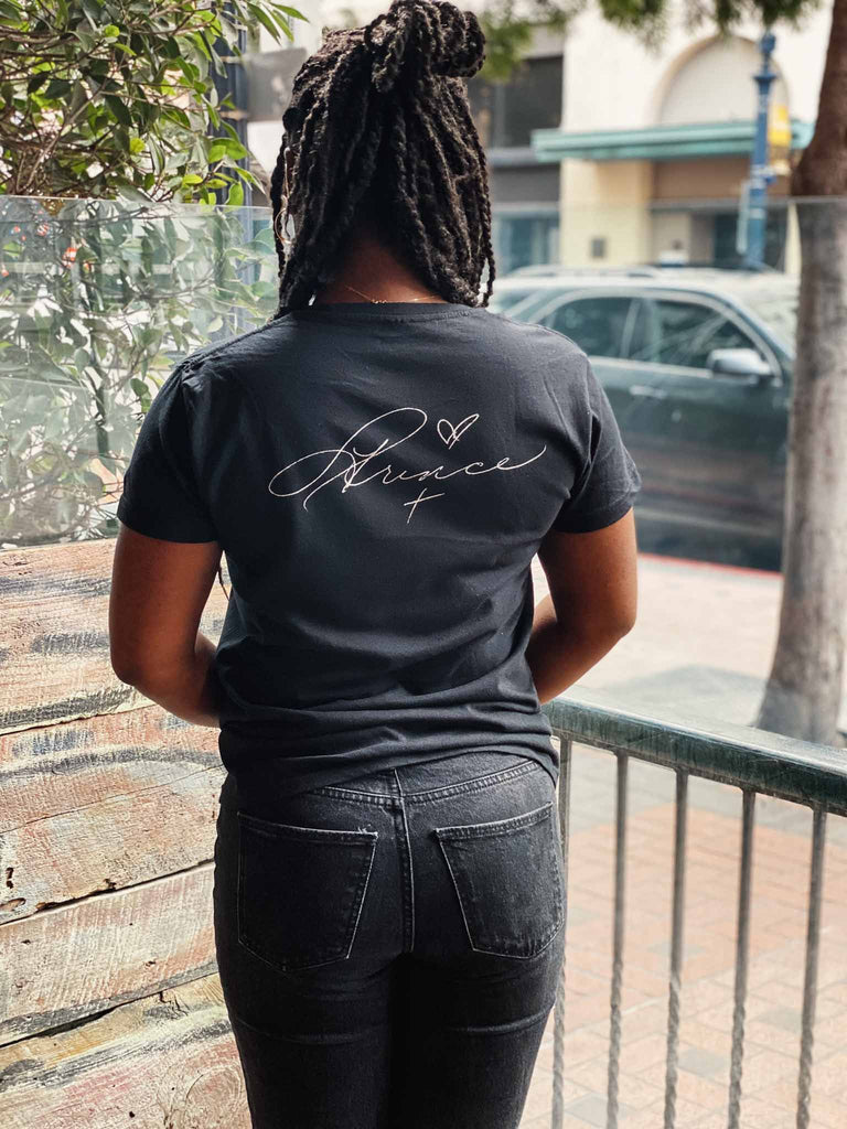 Woman modeling the Prince Parade Signature T-shirt | officially licensed tee with Prince on the front and his signature on the back | Available at Rock & Roll Jane