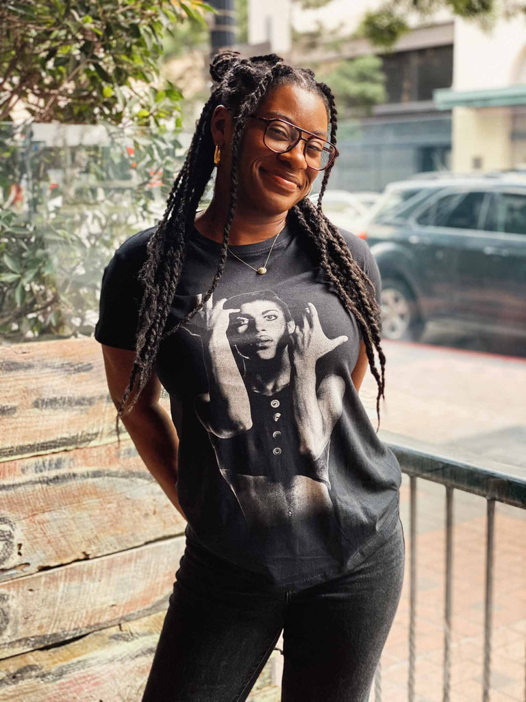 Woman modeling the Prince Parade Signature T-shirt | officially licensed tee with Prince on the front and his signature on the back | Available at Rock & Roll Jane
