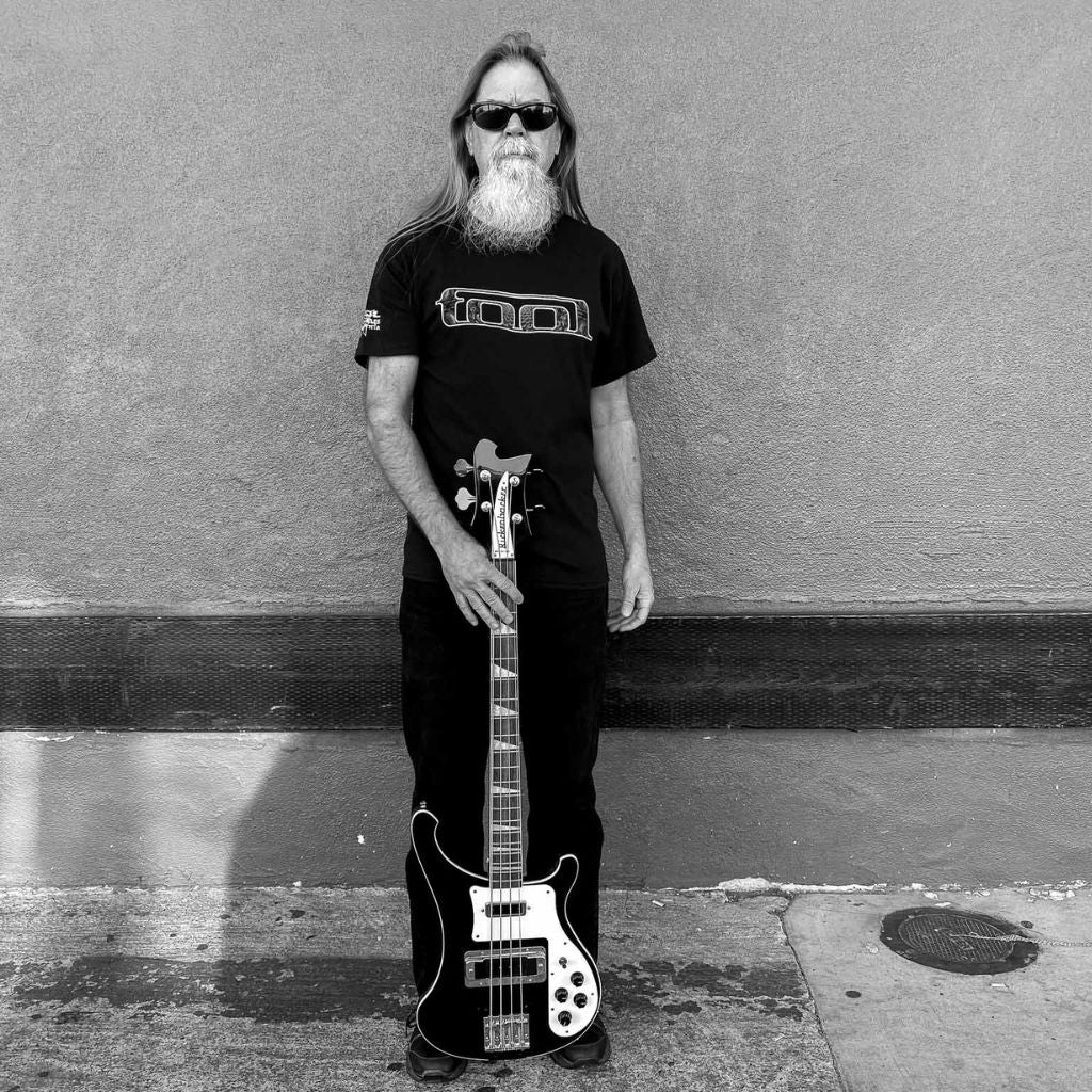 Bass player holding his Rickenbacker bass wearing an officially licensed Tool t-shirt available at Rock & Roll Jane