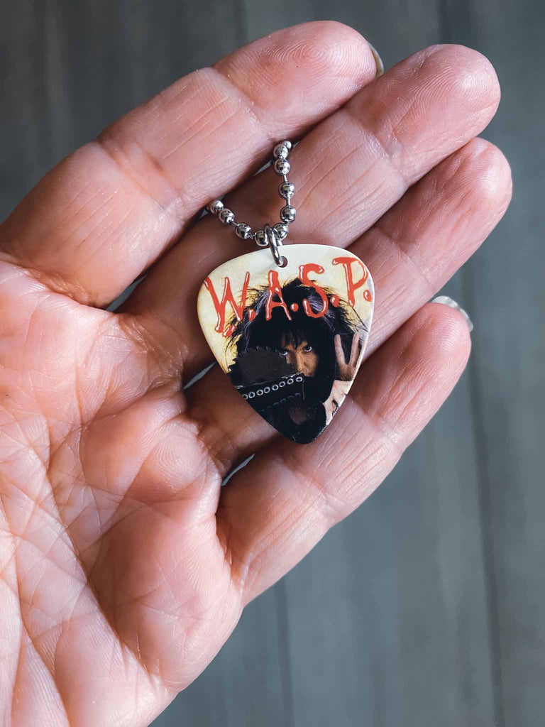 W.A.S.P guitar pick necklace | artwork from the band's 7" single "I Don't Need No Doctor" | 18" silver ball chain with extra cord | Available at Rock & Roll Jane | Officially licensed band tees and accessories